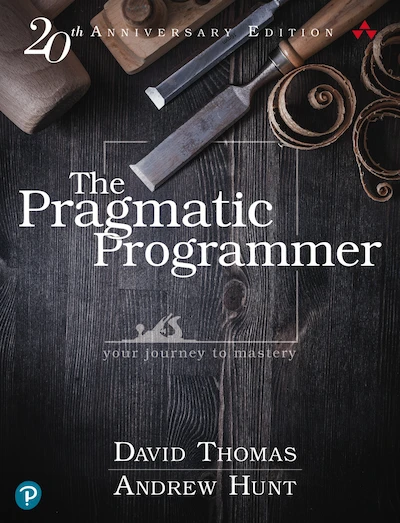 The Pragmatic Programmer book cover has an old wooden surface with hand tools and wood cuttings