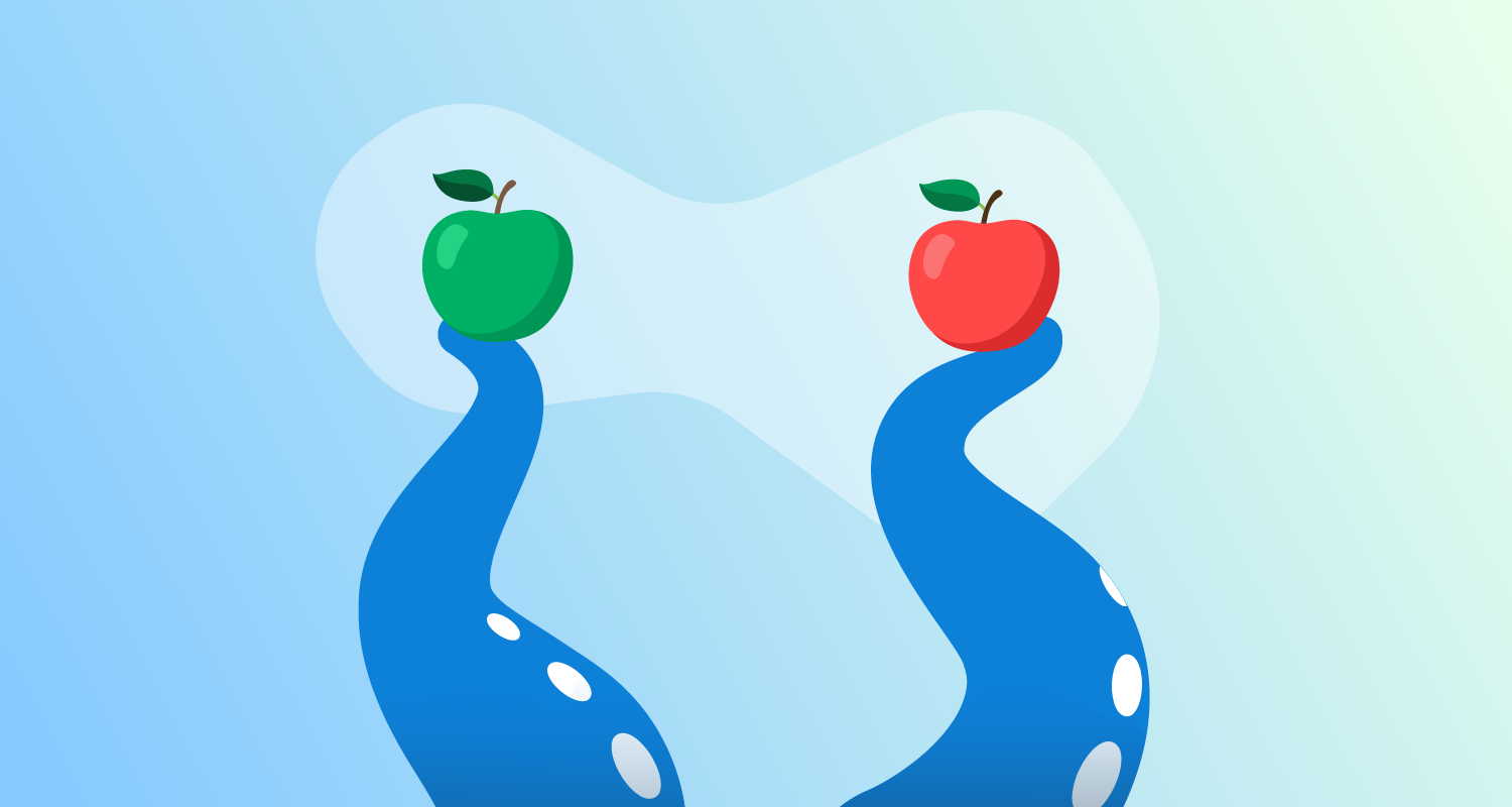 An octopus holds up a red apple and a green apple.