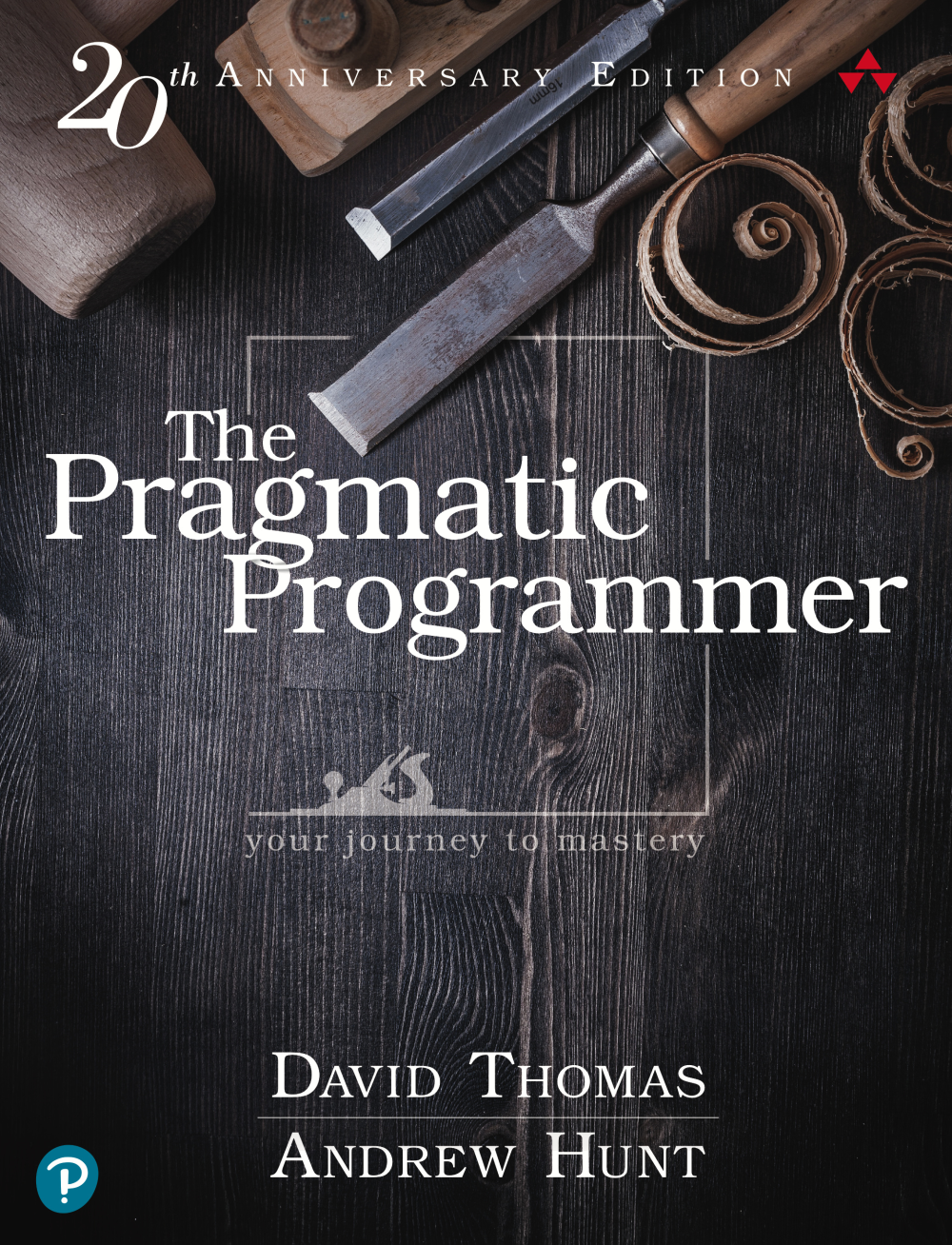 The Pragmatic Programmer book cover has an old wooden surface with hand tools and wood cuttings